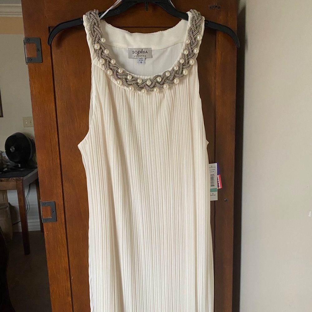 Semi formal creamy white dress with beaded neckline.
